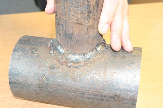 overall view of my pipe weld with my hand in view for scale